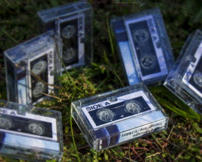 a murder of microcassette in the grass